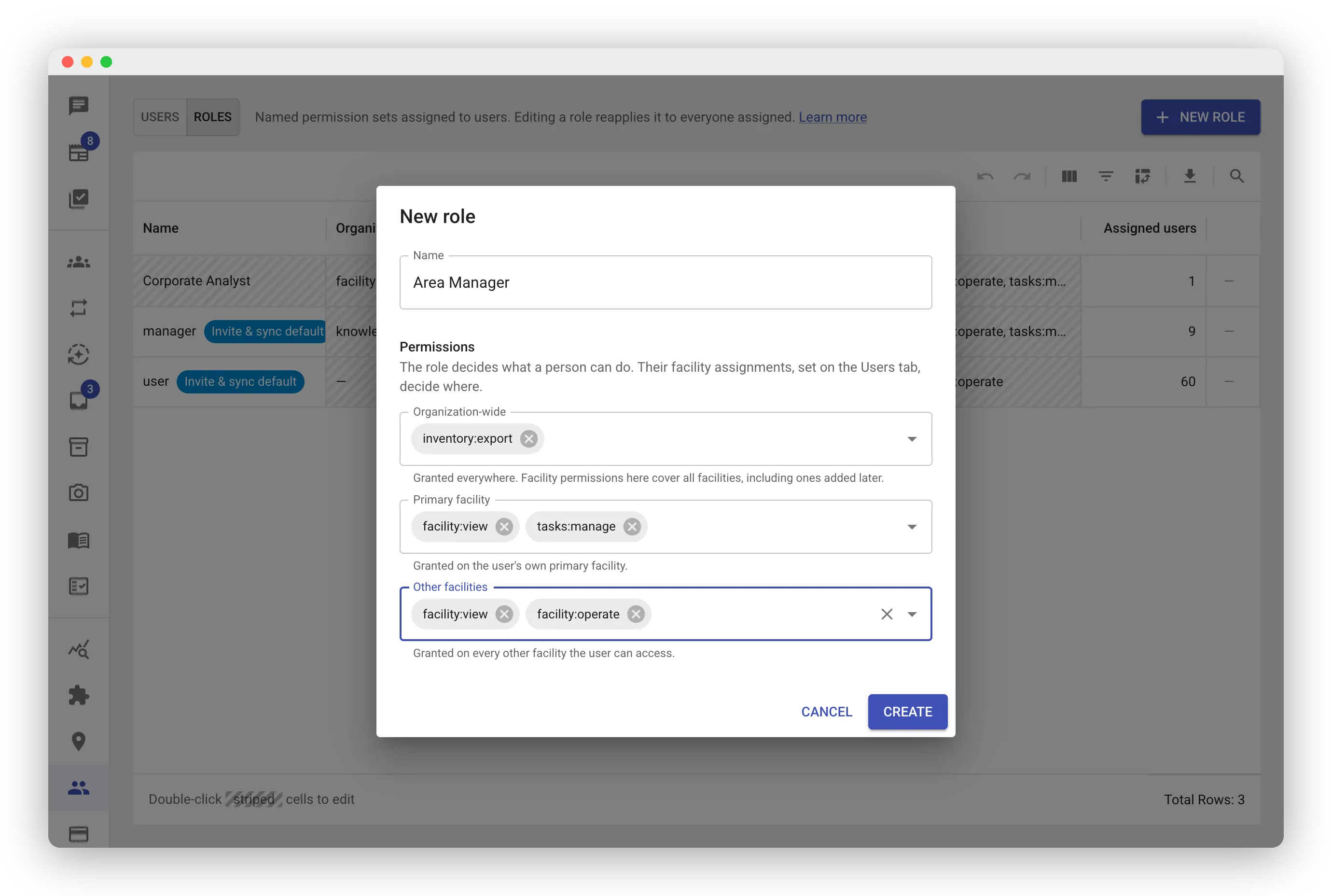 “New role” dialog over the Roles grid. A Name field contains “Area Manager”. Below it, a Permissions header notes that the role decides what a person can do and facility assignments decide where. Three permission fields follow, each with helper text: Organization-wide holding an inventory chip, Primary facility holding facility and tasks chips, and Other facilities holding facility and facility chips. Cancel and Create buttons sit at the bottom.